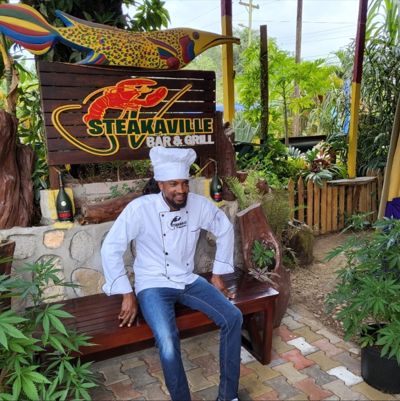 Chef outside Steakaville Rest Stop in Claremont, Jamaica